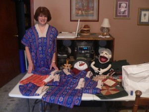 Theresa with the serapes that she is helping the women sew