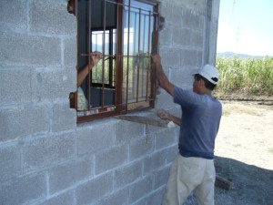 Javier places a window into the new building. There is now easy shortcuts when one works with concrete