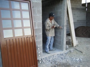 Marcelino preparing to place the door into the storage room