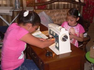 Alicia practicing on her new machine while her daughter watches
