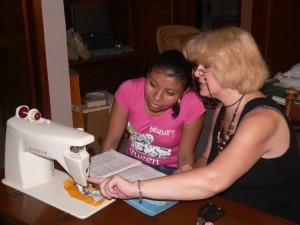 Theresa training Alicia on new sewing machine