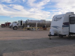 This is the scene outside our front door. This is the tongue of our travel trailer that you see. Not much room between us and the trucks