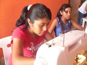 Young sewing students busy at their machines