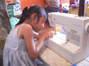 Little Ana at her sewing machine