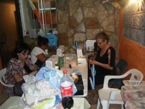 Cristina and the women busy in the sewing department