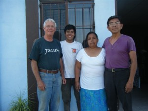 Javier and Cristina stand with Carl Thompson and Armando at the farm