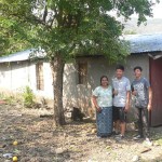 Cristina and boys outside donated house