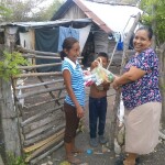 Cristina distributing food care packages to poor children in Buenos Aires. When the children could not come to the Hidden Manna program she found ways to go to them.